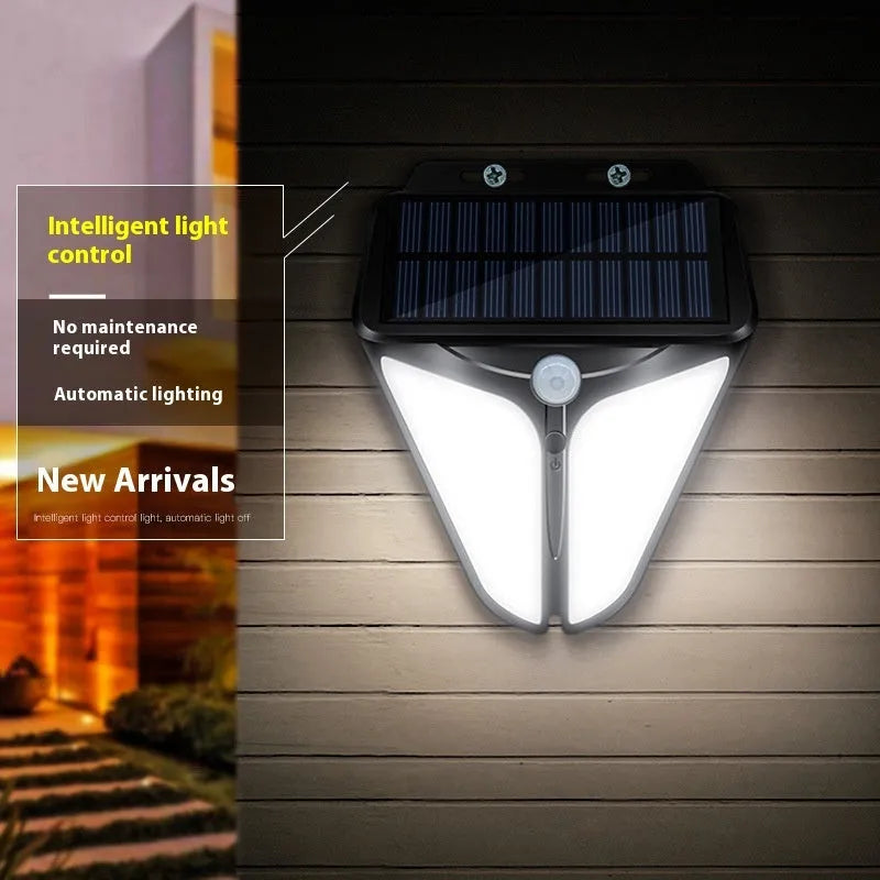 Heart shaped human induction solar wall lamp with binocular lights on an exterior wall in a villa courtyard