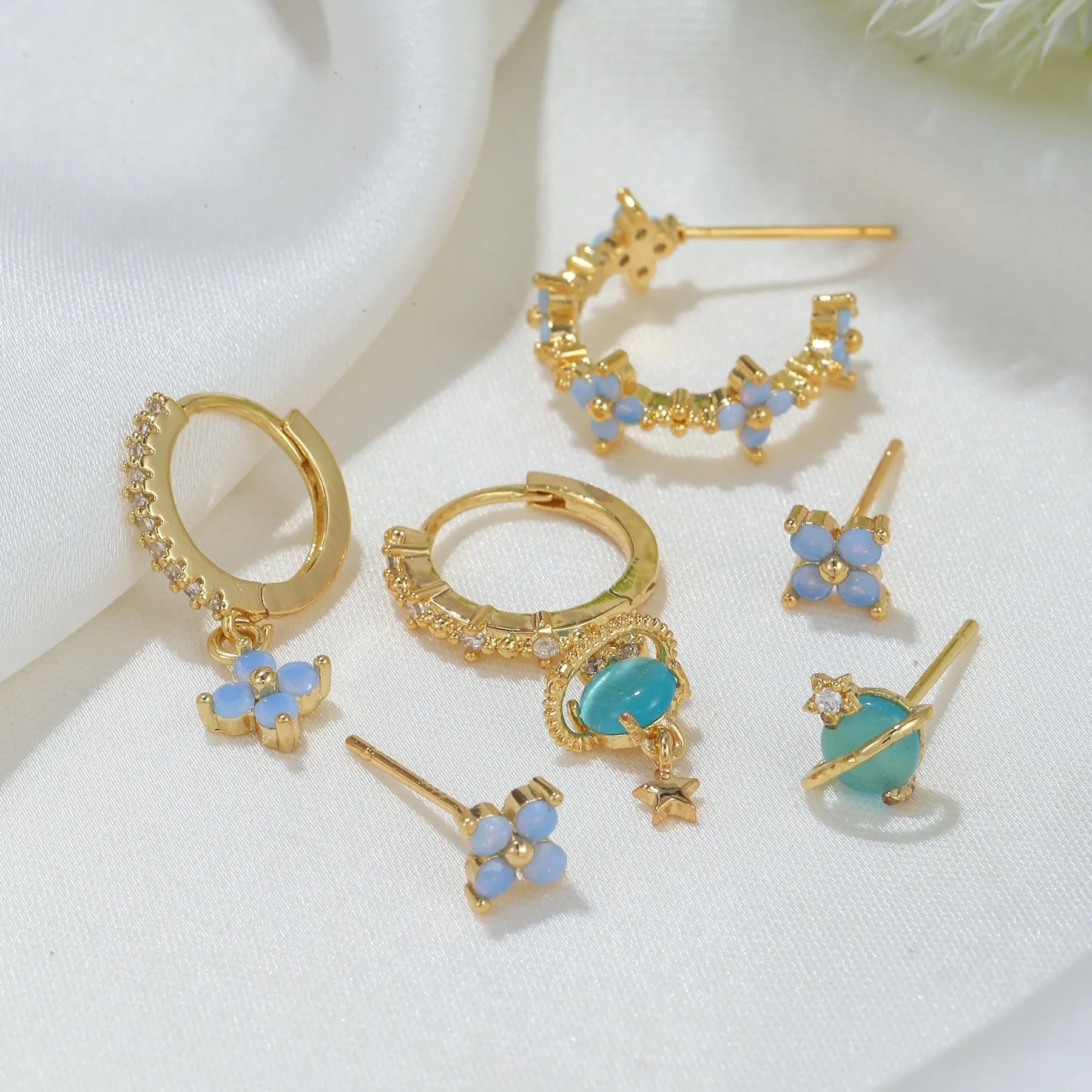 Gold and silver blue floral stud earrings with zircon mosaic on copper.