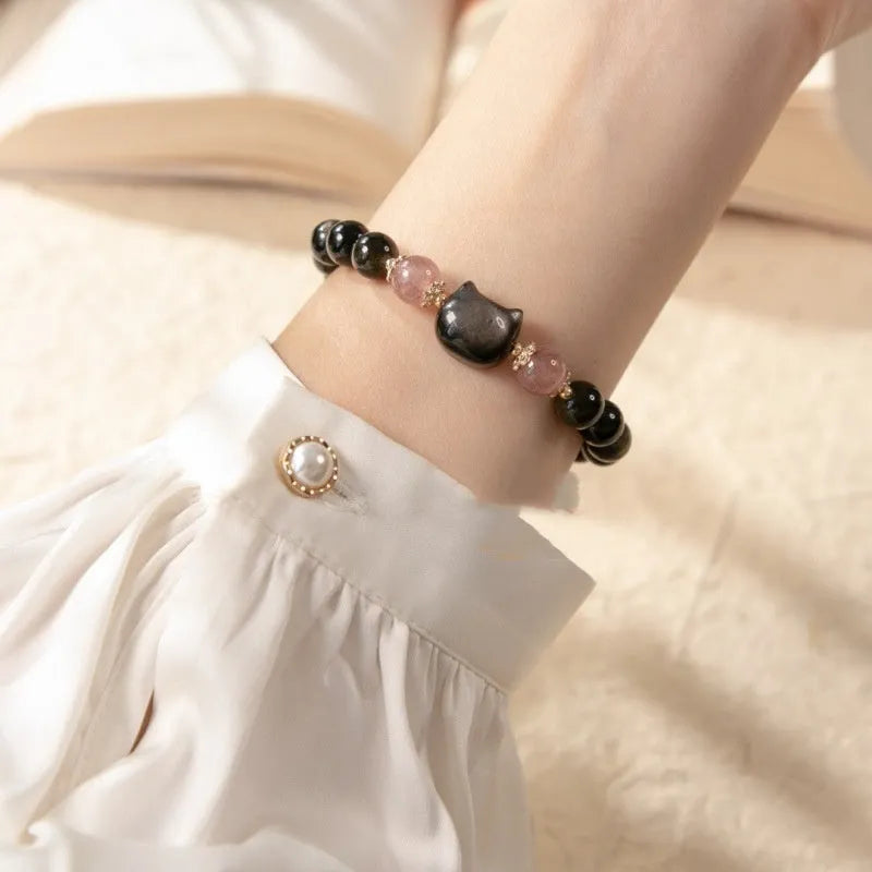 Black obsidian bead bracelet with cat charm on adjustable fastening