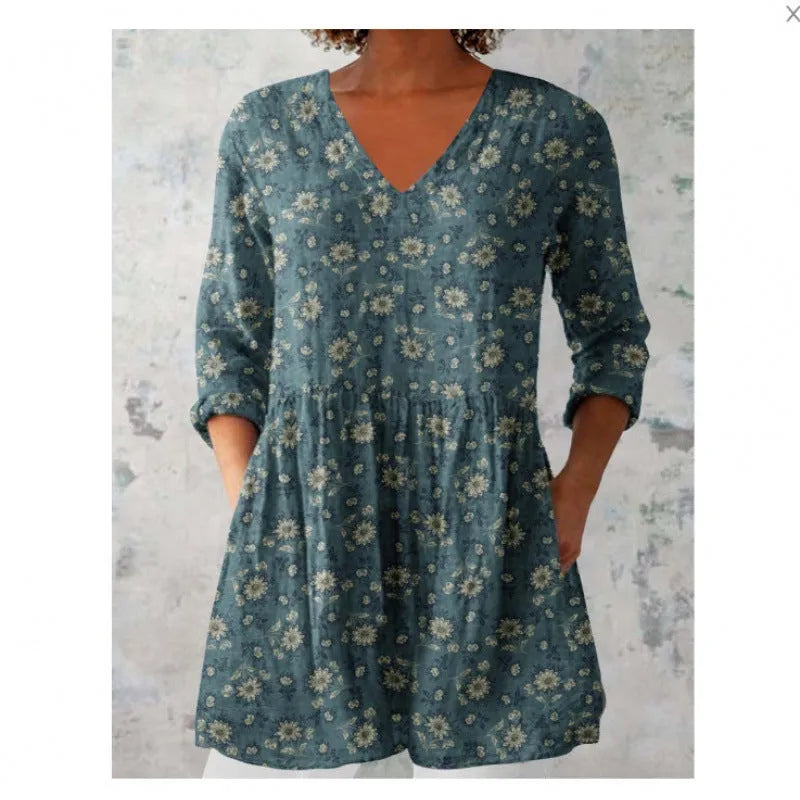 A loose-fit women's dress with a wave print pattern, wide waist, and three-quarter length sleeves.