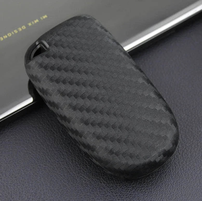 Carbon fibre pattern silicone protective case for a Dodge, Chrysler, or Fiat car key remote with a large head buckle.