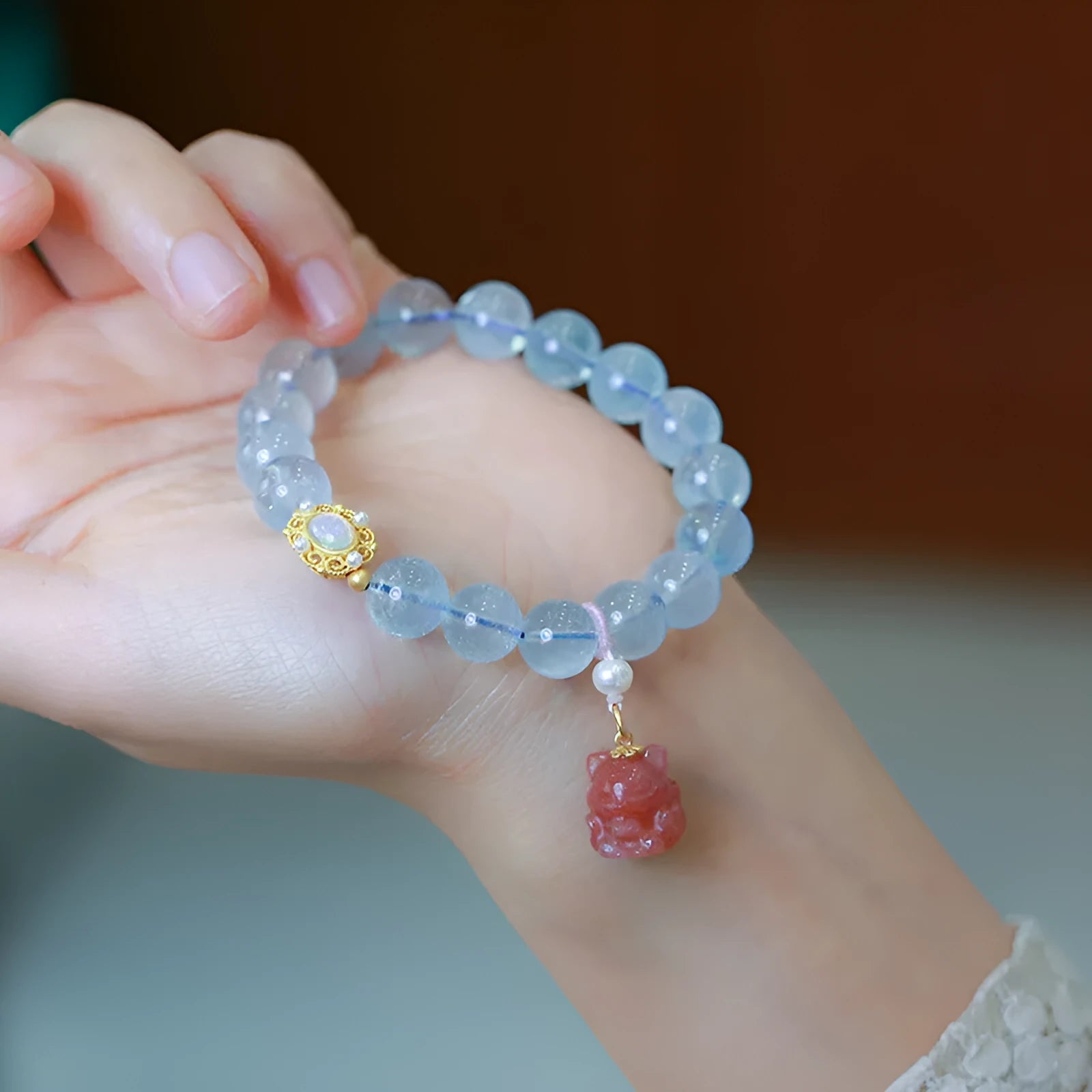 DIY adjustable aquamarine bead bracelet with pearl accents and a Chinese style fox Fengjiu charm.