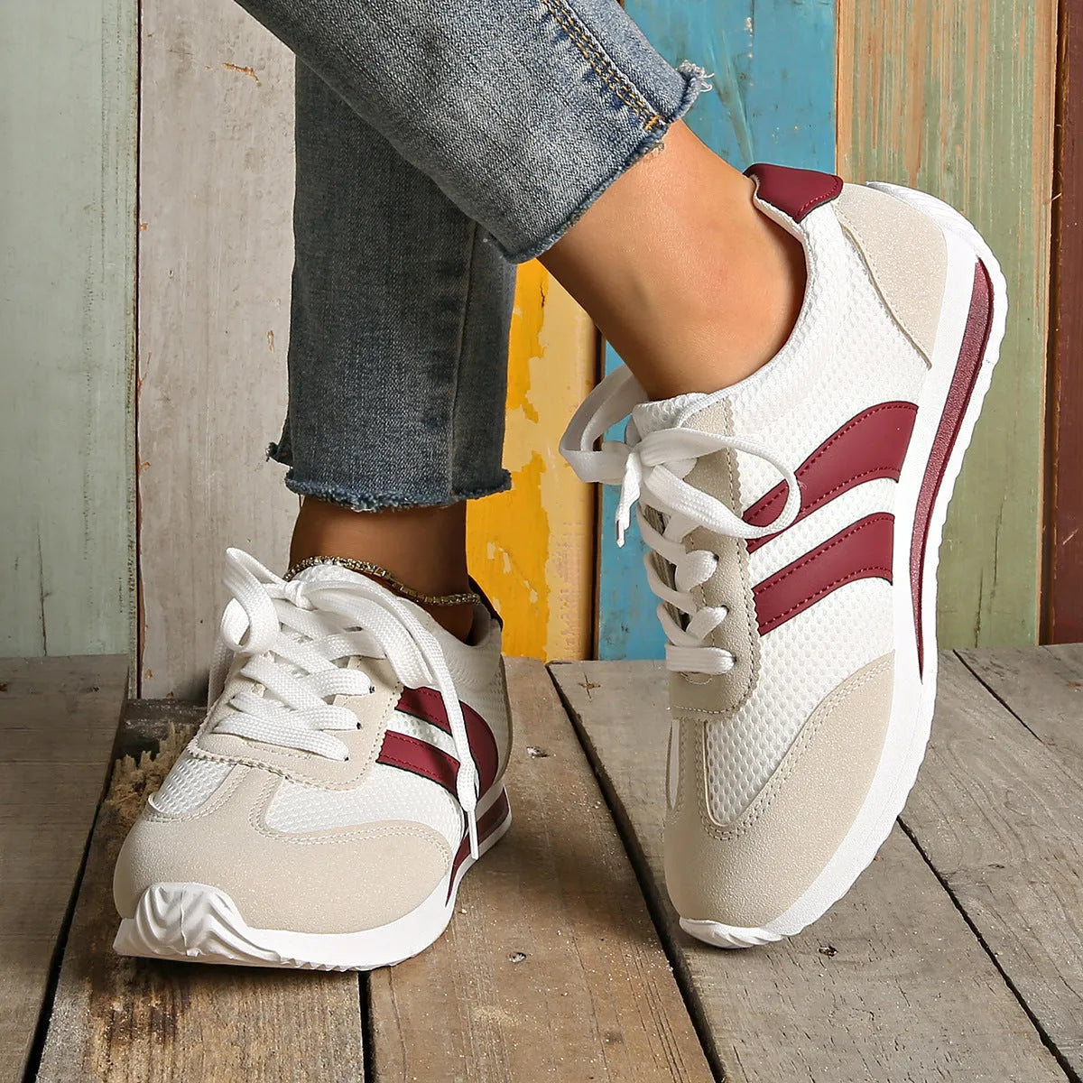 Wine red Cortez retro-style low-top sneaker with a cross-strap over a breathable mesh upper.