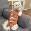 A pink lace-up cat recovery suit on a grey cat, showing the back closure and full-body fit.