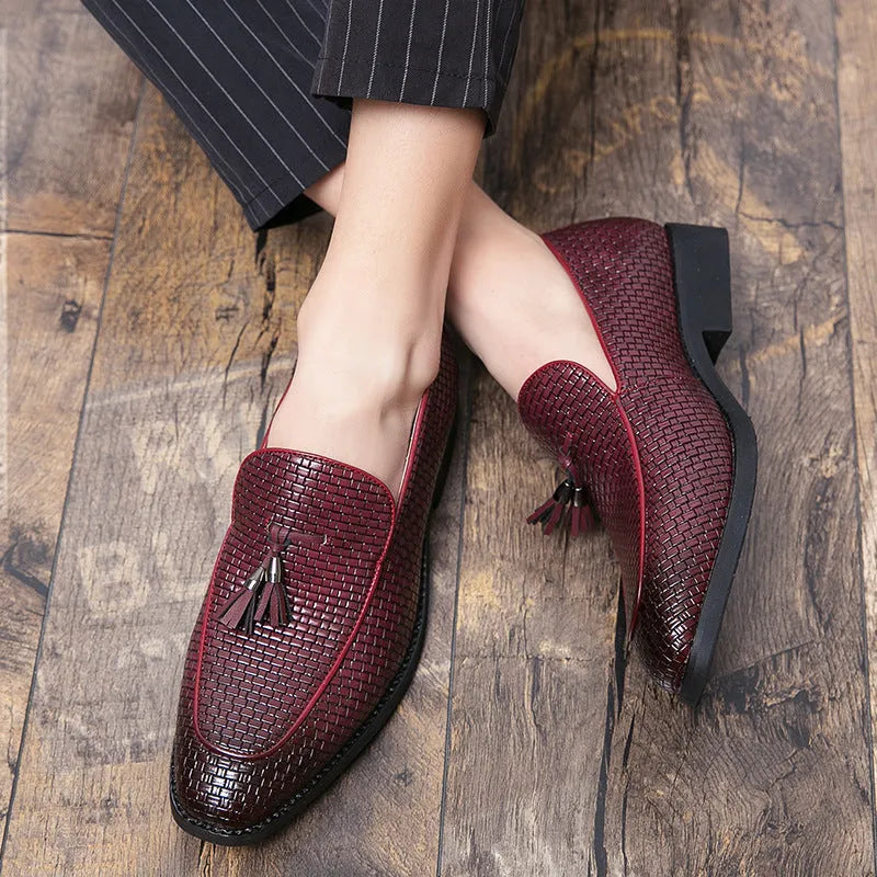 Men's black pointed toe slip-on shoes with a tassel detail on the artificial PU upper.
