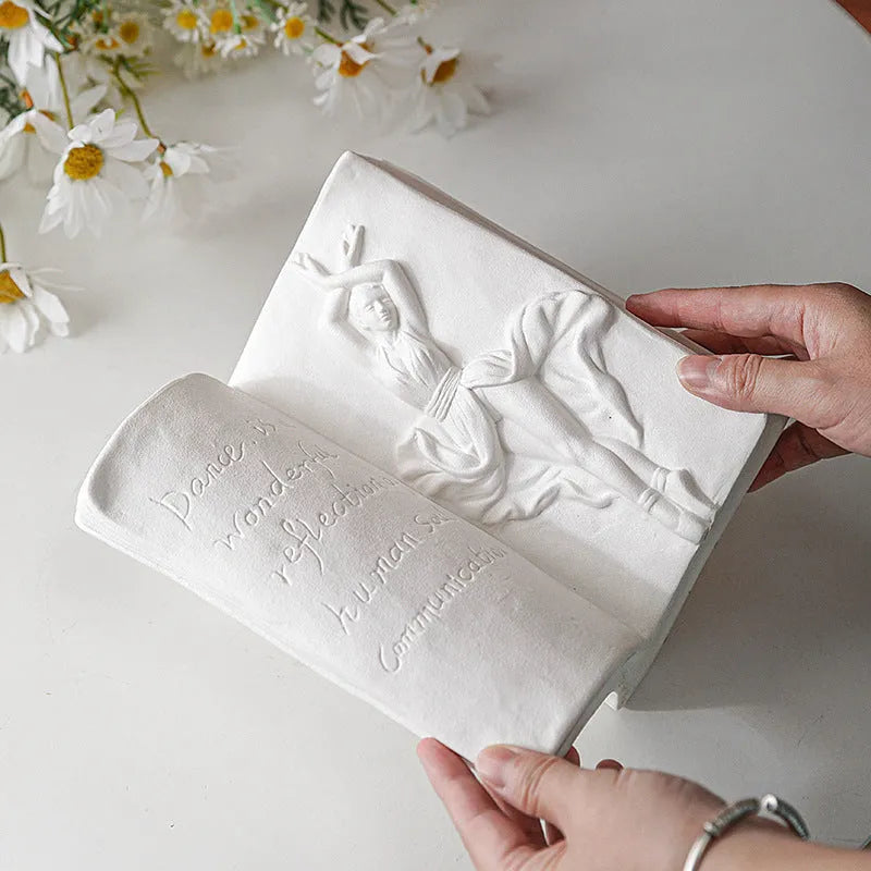 Glazed ceramic book stand ornament in one of four decorative styles on a wooden desk.