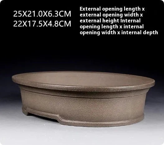 Handmade antique oval bonsai flower pot made from purple sand clay, dimensions 25x21x6.3 cm.