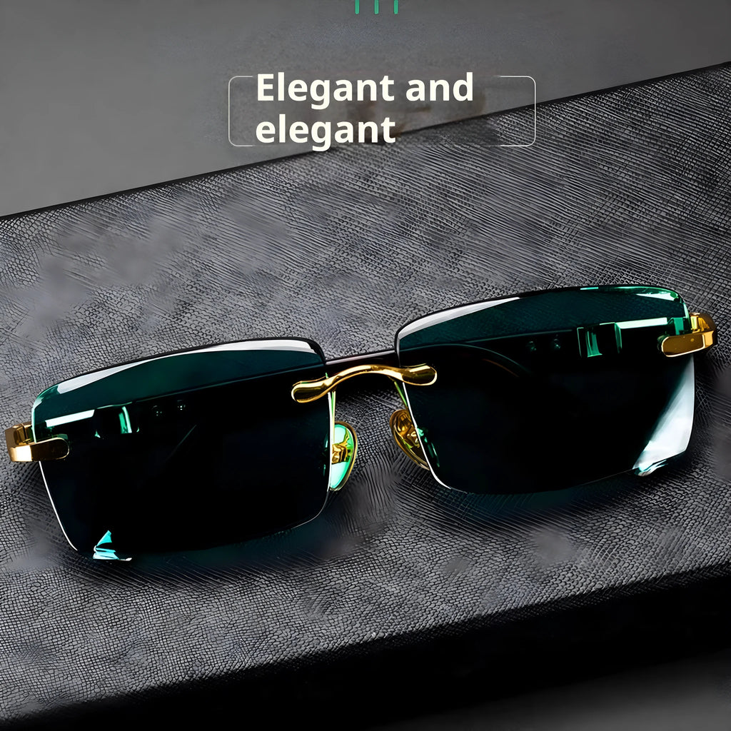 Frameless sunglasses with dark green tinted lenses and a black hard-shell case on a table.
