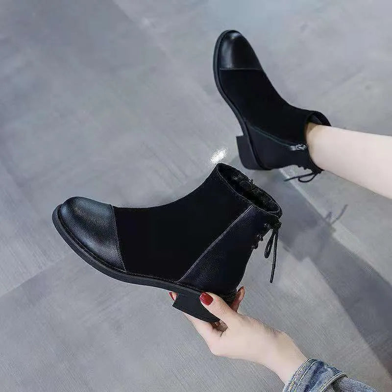 Black women's knee-high Martin boots with a side zip and decorative bow.