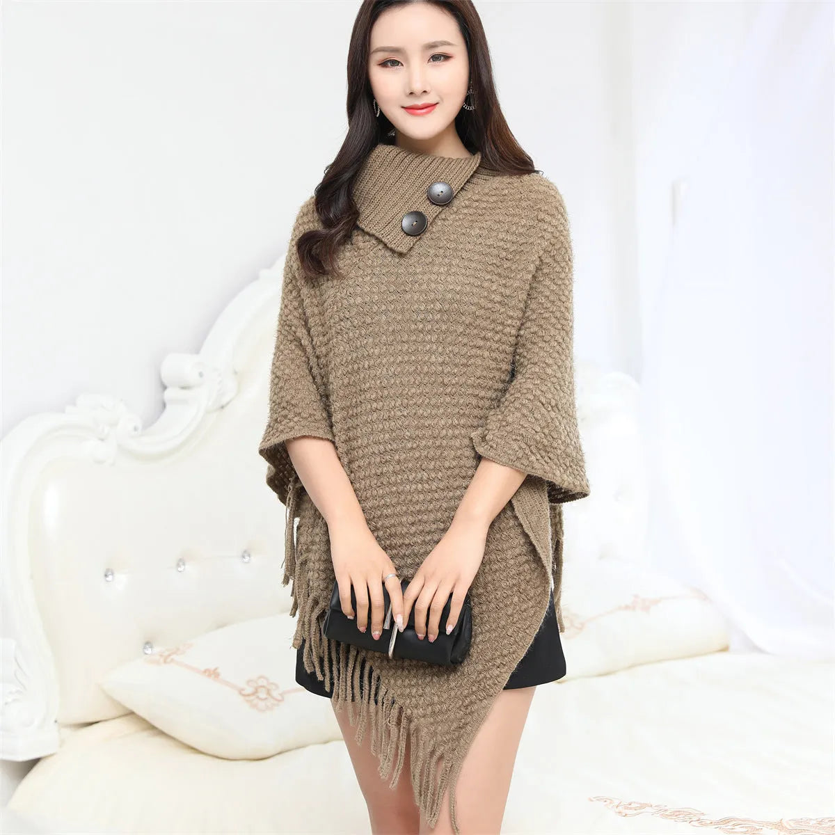 Women's sleeveless knit shawl cloak with dotted pattern in acrylic fibre shown in various colours