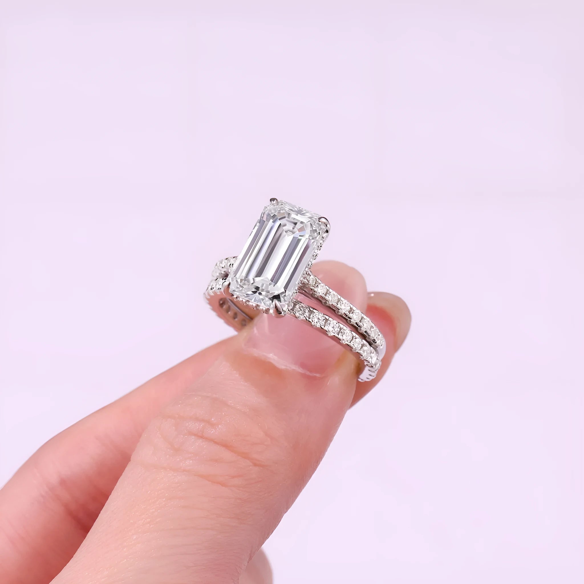 Pair of matching geometric S925 sterling silver rings with white finish on a flat surface