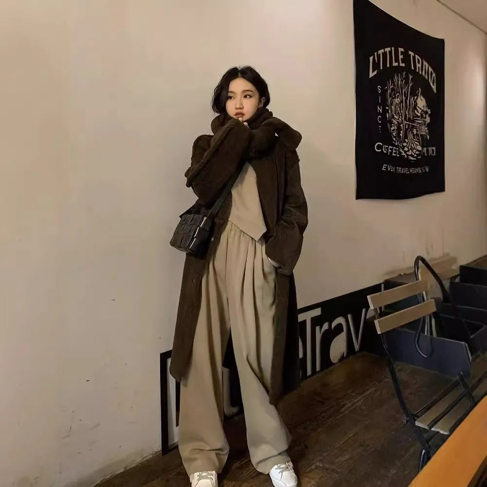 Women's loose brown polyester sports suit with top and trousers on a hanger.