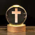 White crystal ball desk lamp with warm light on a solid wood base.