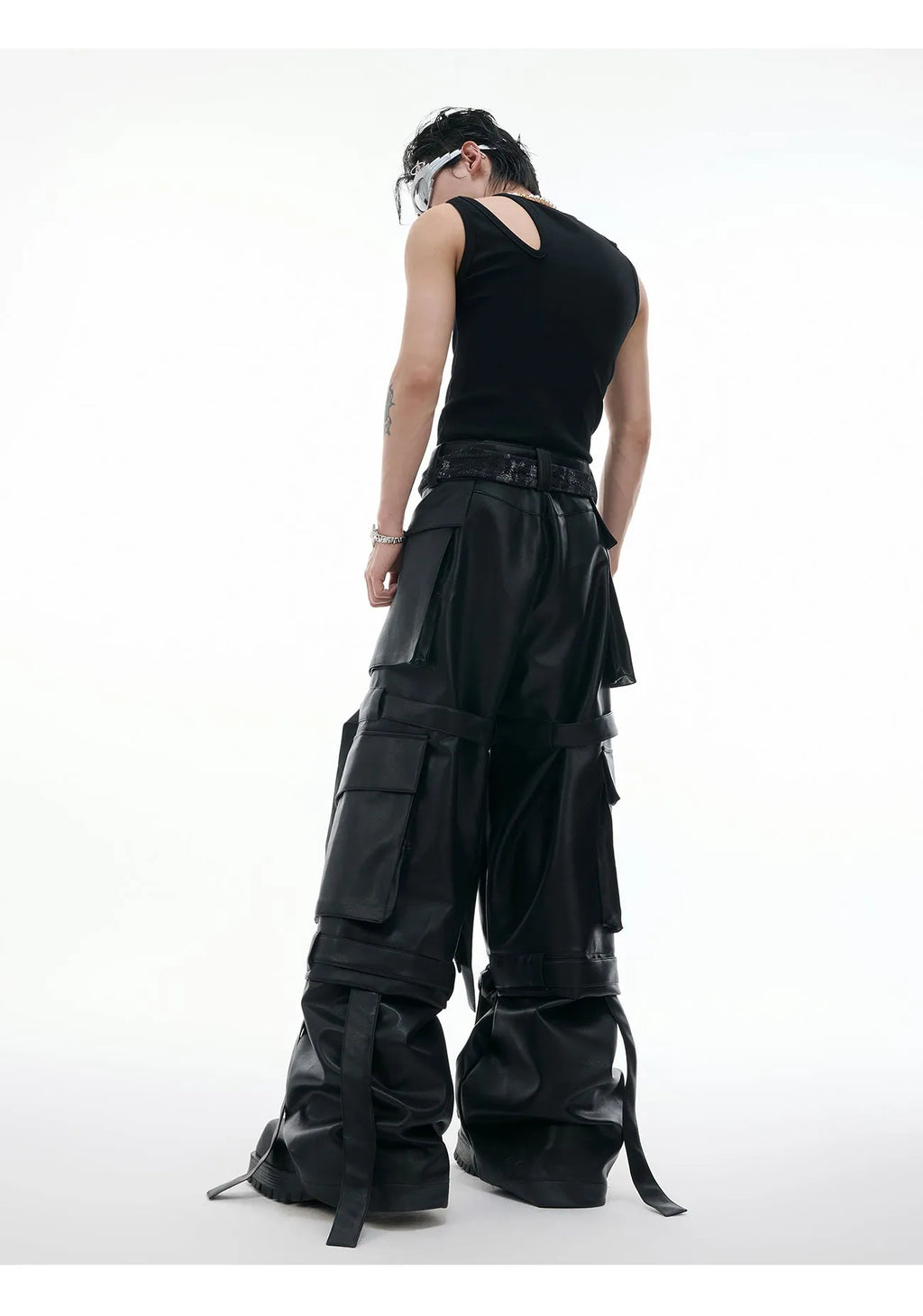 Black loose-fit multi-pocket trousers with quilted stitch detailing on a mannequin.