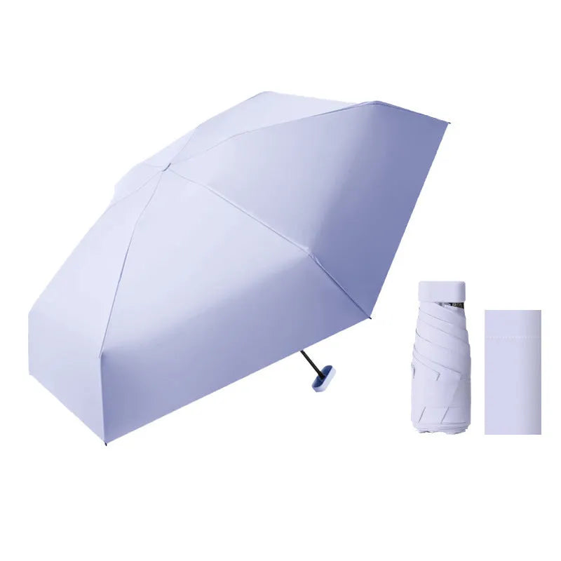 Ultra-light six-fold flat capsule sun protection umbrella in sky blue with manual open mode and rubber handle.