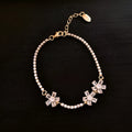 Gold-coloured women's bracelet with geometric quadrilateral design and zircon stone inlay