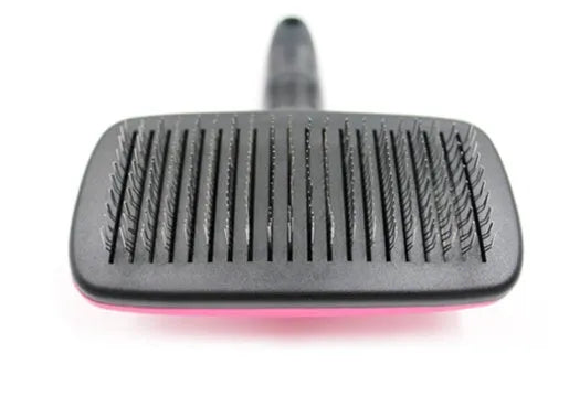 Rose red pet grooming comb with stainless steel teeth on white background