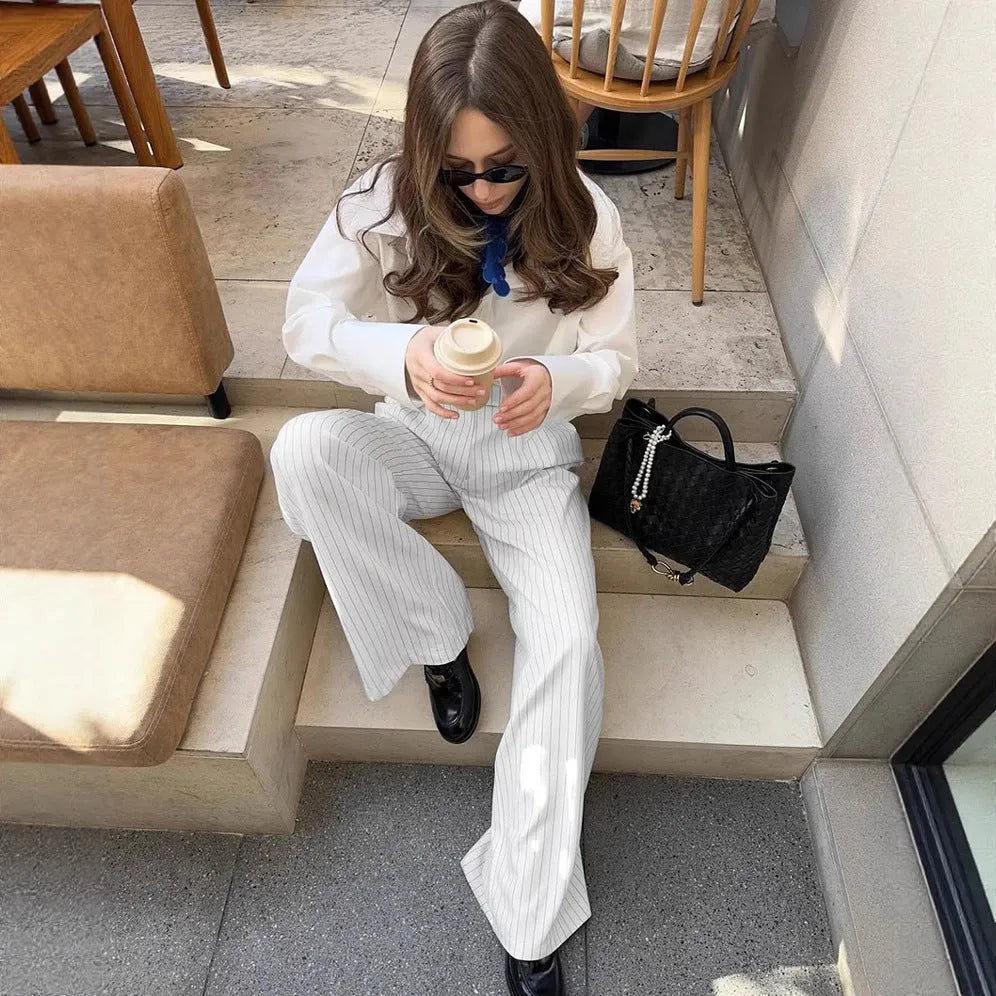 White striped wide-leg trousers with zipper detailing on loose casual silhouette