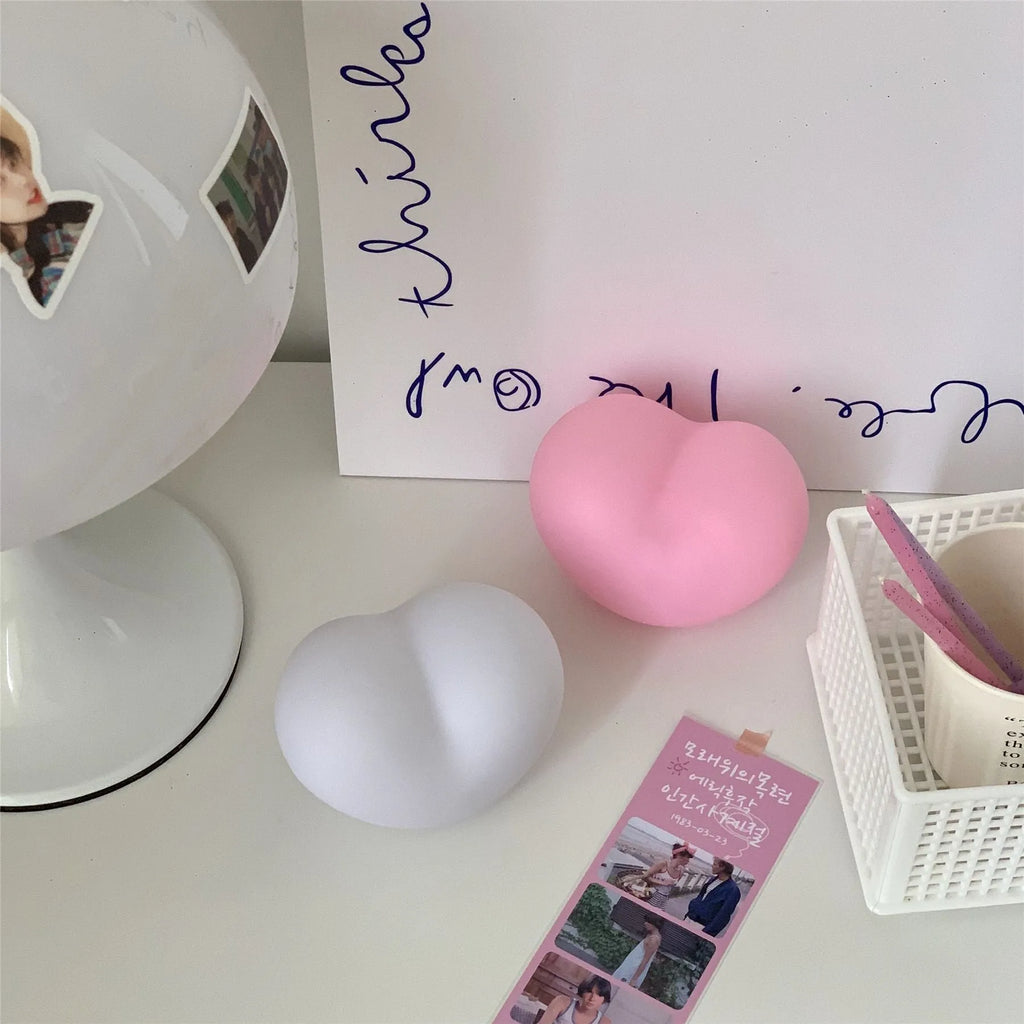 White and pink vinyl atmosphere lamps in small and large sizes with warm glowing light.