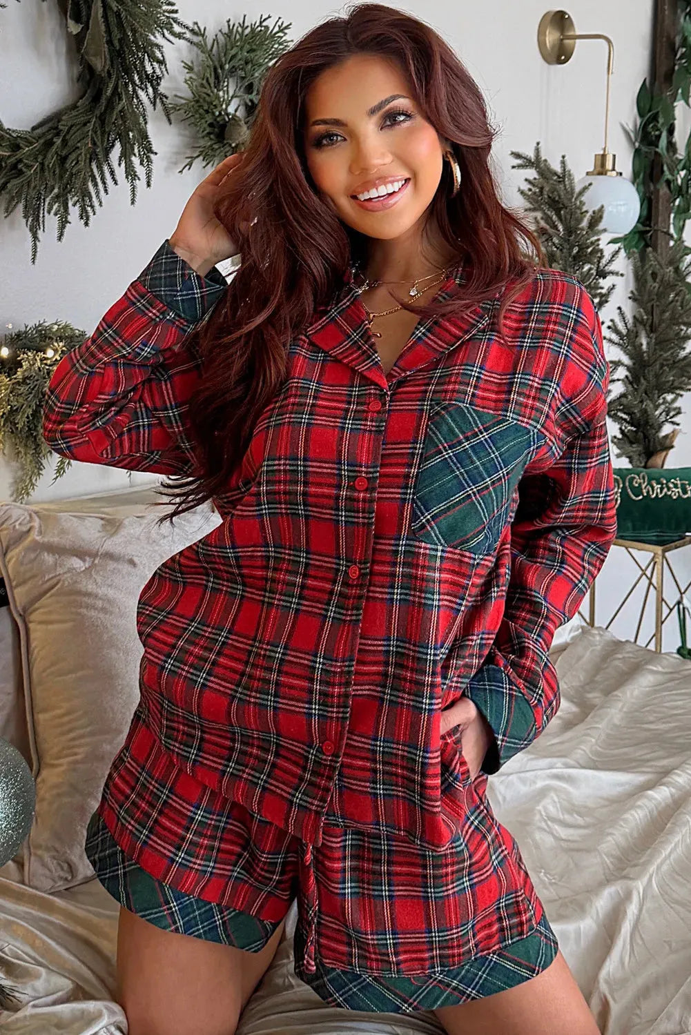 Red and black plaid Christmas pyjama set with contrast fabric patches on the shirt and matching shorts.