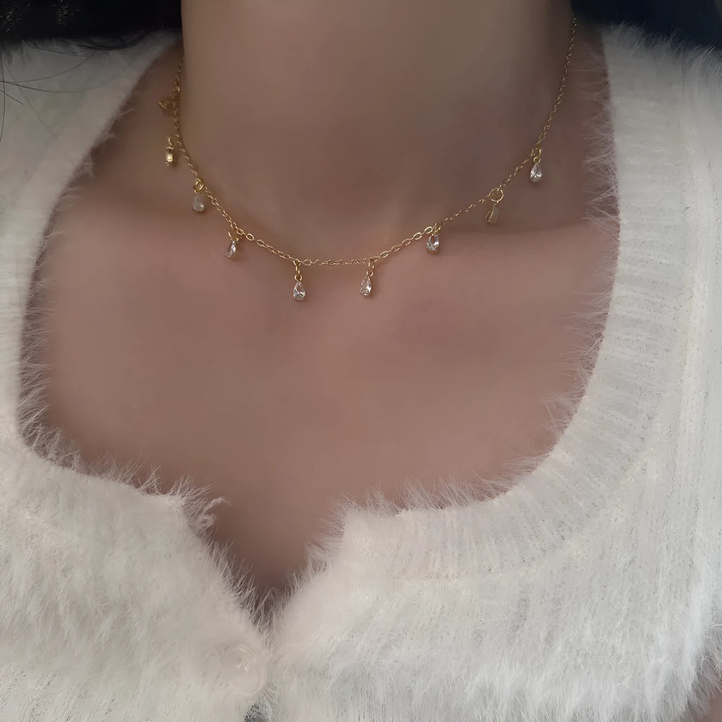 Zircon necklace, earrings, and anklet set for women with geometric meteor shower pendant.