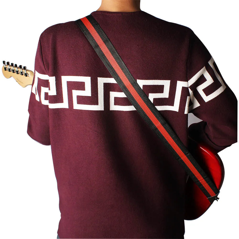 Universal woven crossbody strap for guitar, bass, or ukulele in red, showing clip and adjustable buckle on 110cm length.
