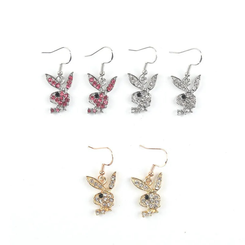 Close-up of a pair of cute rabbit-shaped stud earrings with sparkling cubic zirconia stones on a silver-coloured background.