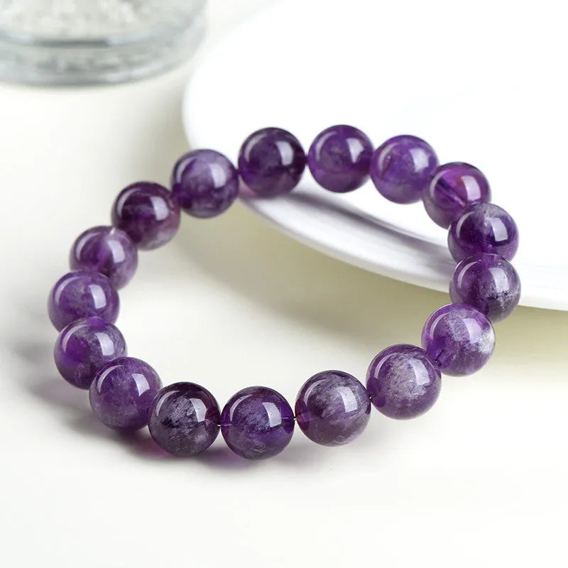 Natural feather amethyst crystal bracelet with scattered Snow Mountain purple beads and geometric Ruyi design.