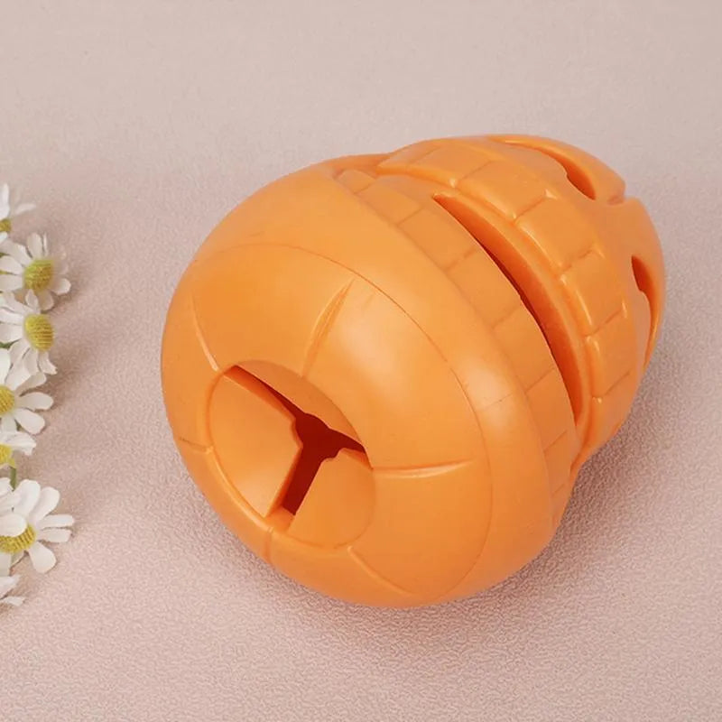 Yellow pumpkin-shaped TPR dog chew toy for aggressive chewers, showing textured ridges.