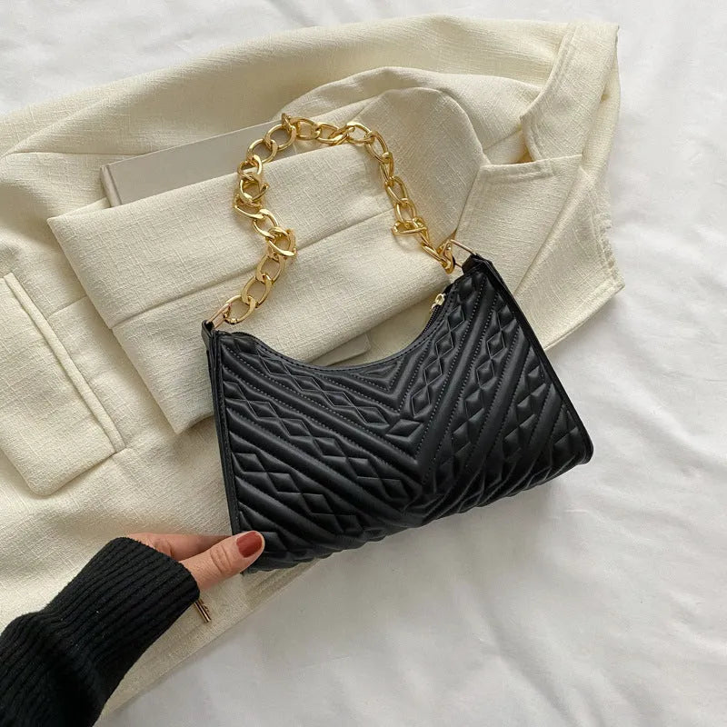 Brown pleated PU baguette shoulder bag with a top handle and long chain strap on a white background.