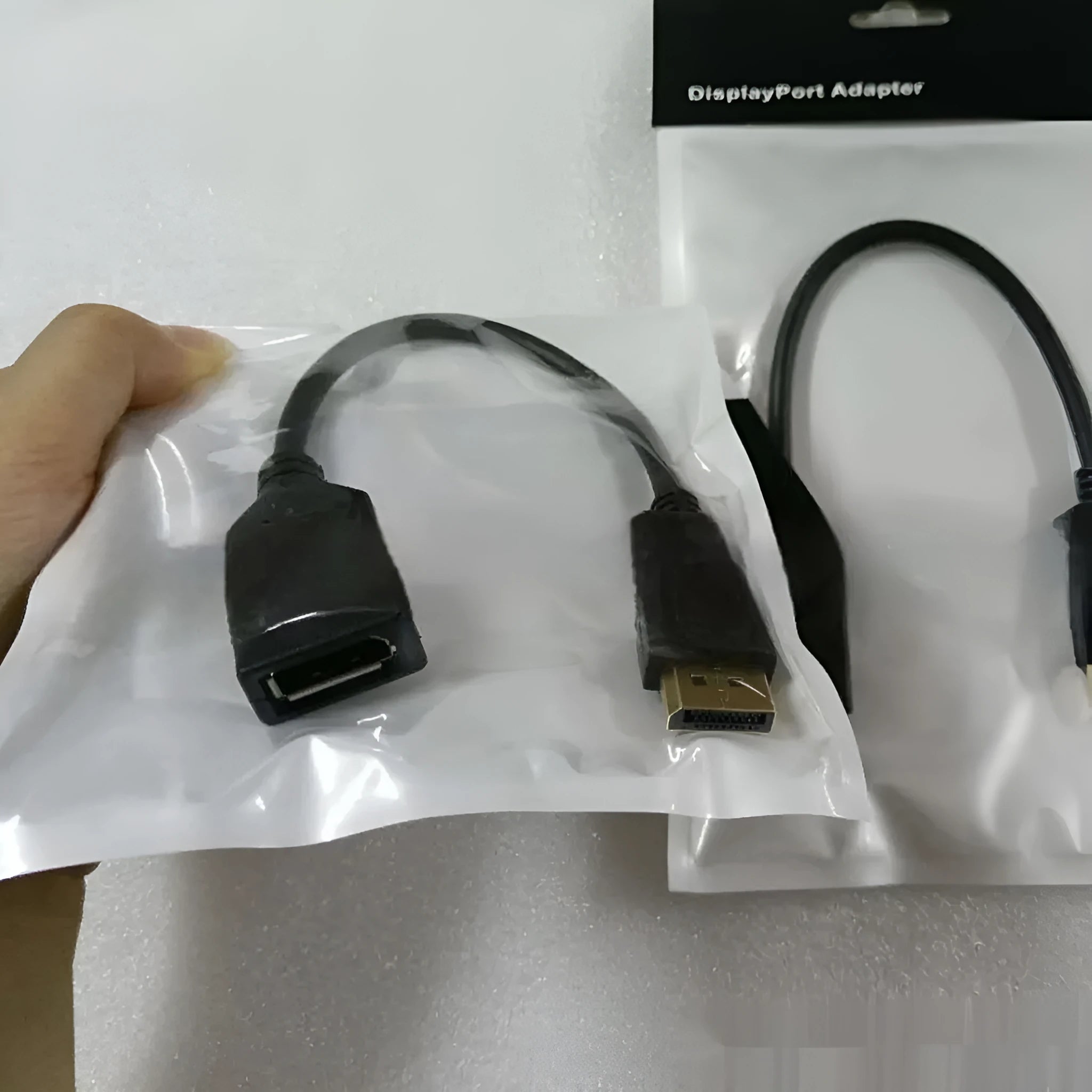 Black Display Port male to female extension cable approximately 10cm long