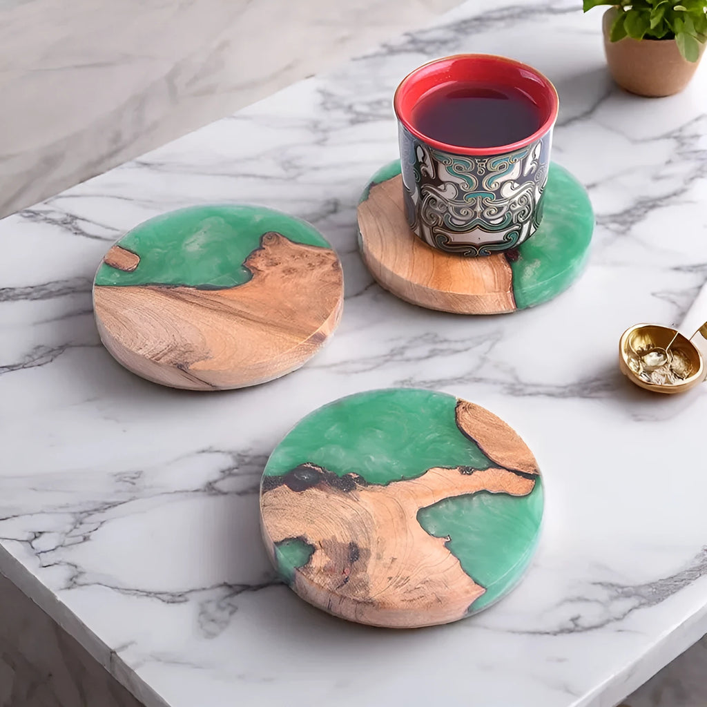 Set of solid wood coasters for tea, showing round green and black versions on a wooden table.