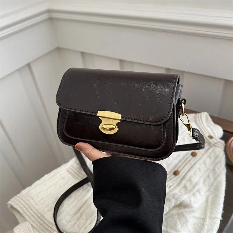 Retro-style small square handbag in soft brown PU leather with a horizontal silhouette.