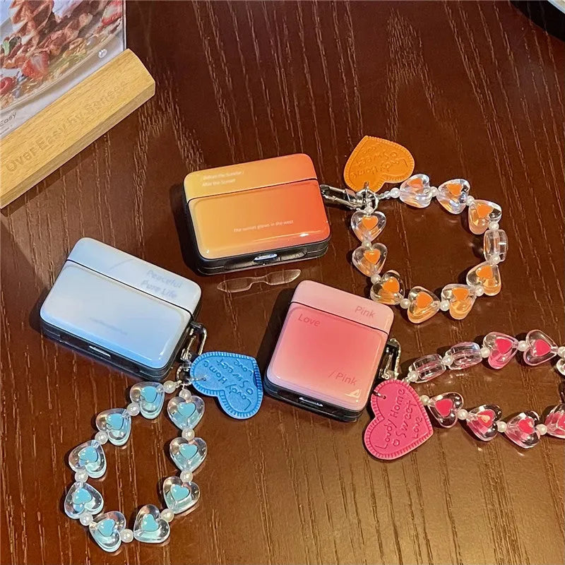 Soft TPU protective sleeve for AirPods 1/2 and Pro/3 in gradient pink, orange, or blue with love pendant.