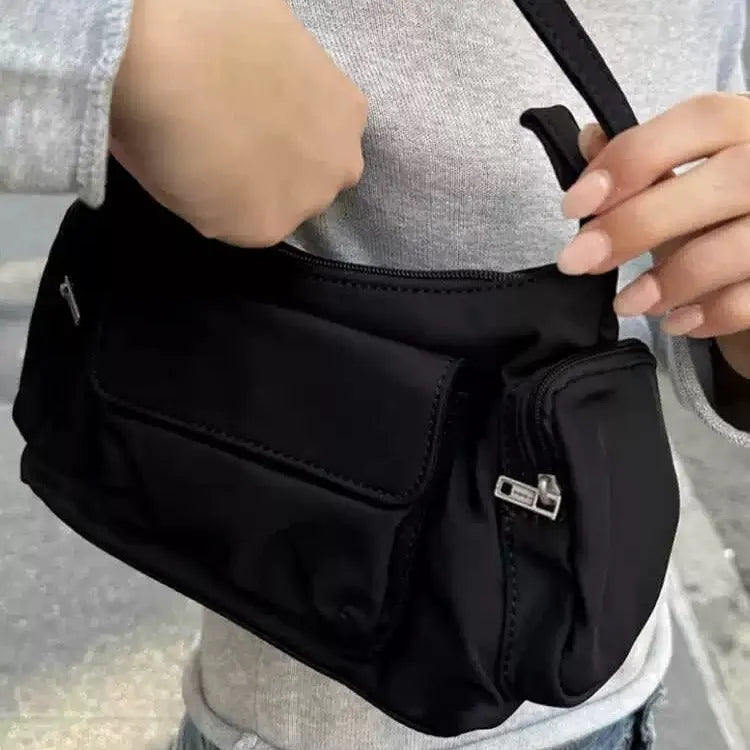 Simple black lightweight nylon shoulder bag with double pockets showing side line detailing