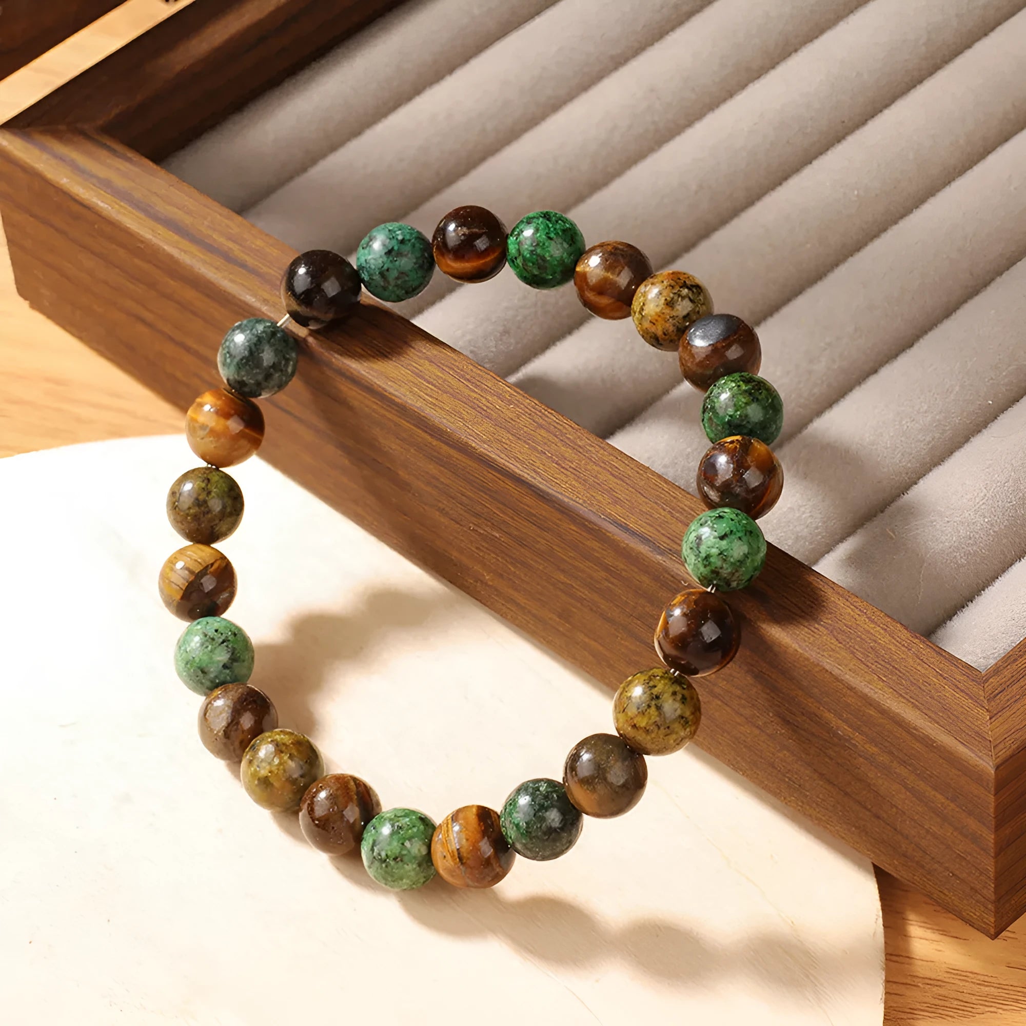 Tigereye natural stone fortune bracelet showing antique floral design and handmade construction