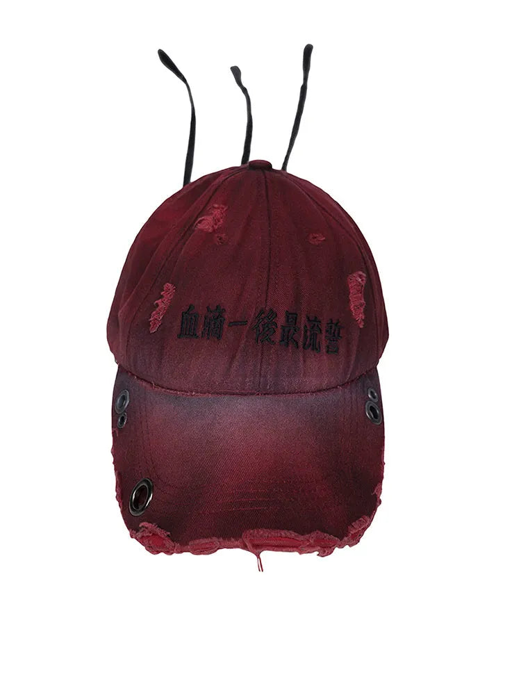 A rose red cotton peaked cap shown on a neutral background