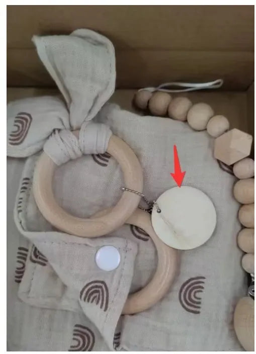 Baby teething gift set with bamboo gauze blanket, wooden chewing ring, woven bell, and developmental toys