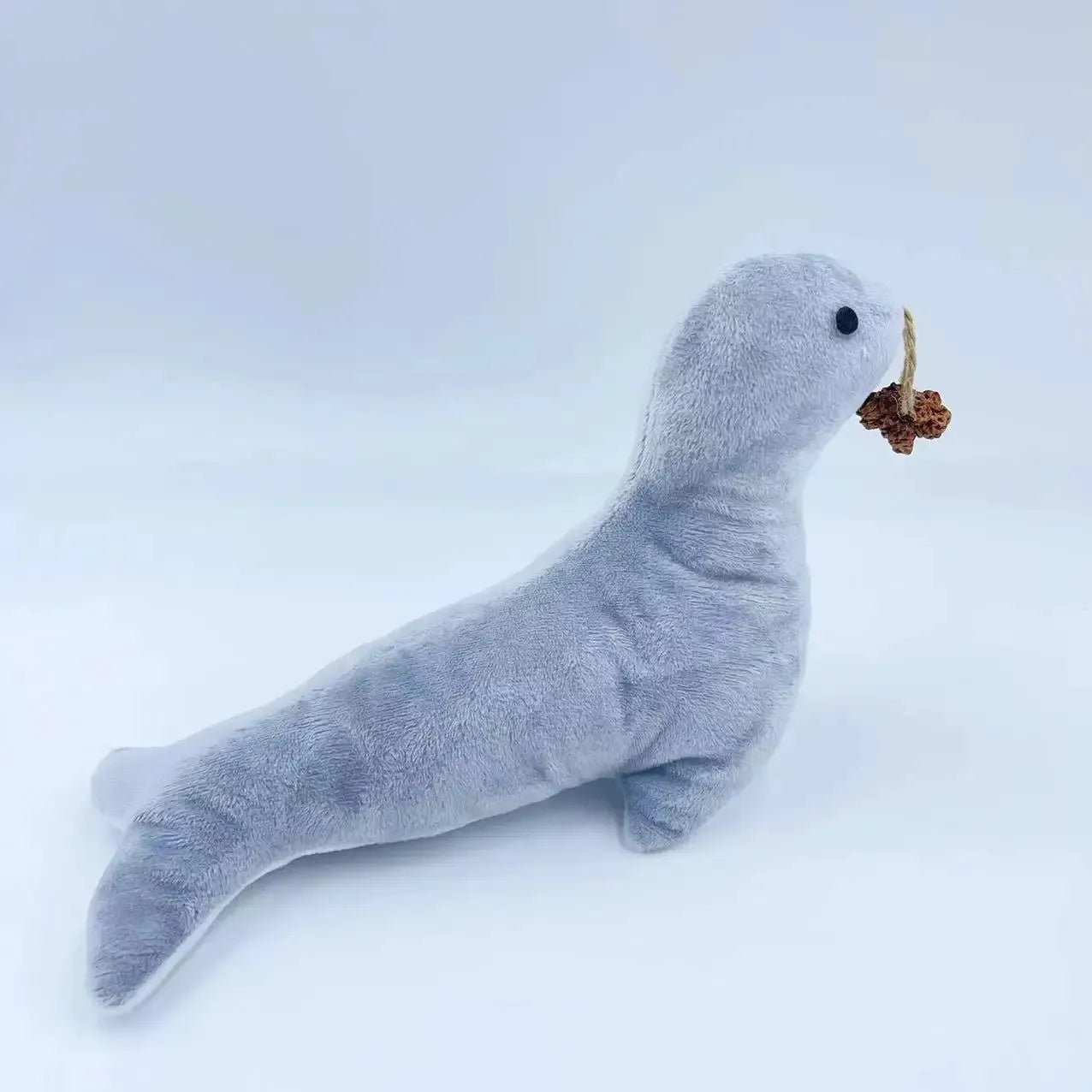 Blue sea lion shaped plush cat toy with bell, teeth grinding texture, catnip and gall fruit.
