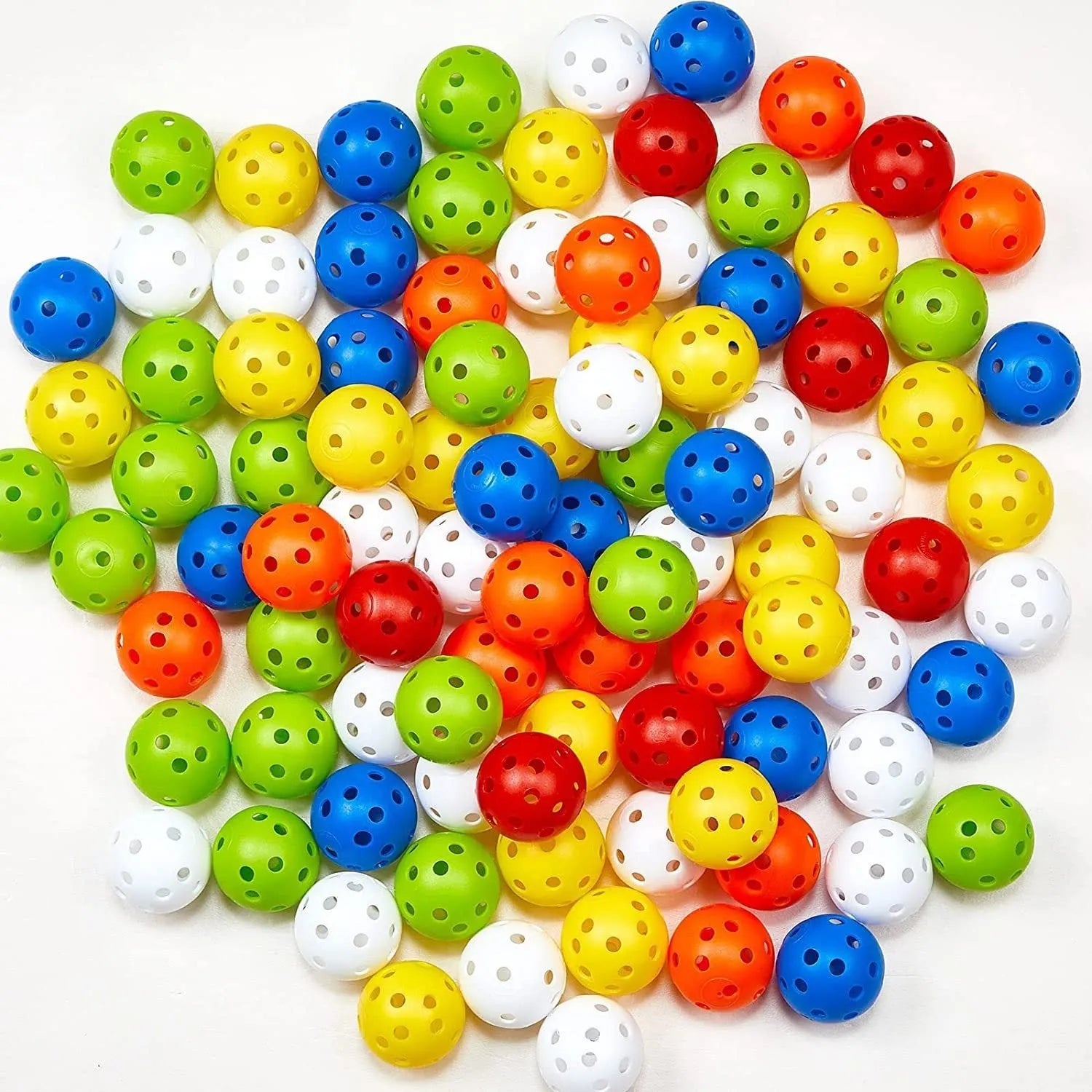 Multi-colour golf practice balls with 26-hole design next to a net storage bag