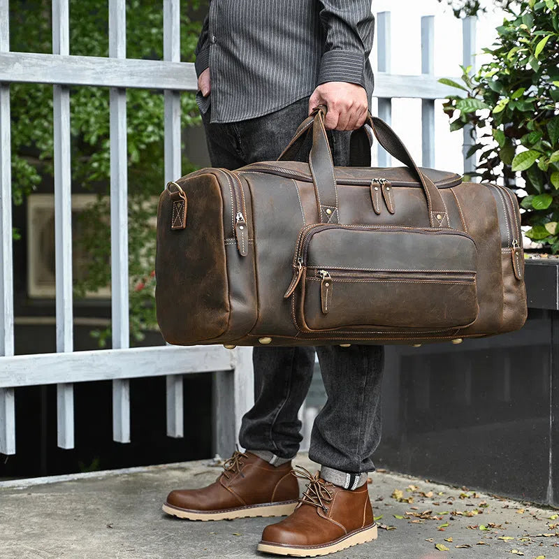 Men's full-grain cowhide leather crossbody bag in dark brown, with stitched seams and shoulder strap, 58cm size