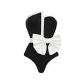 Women's black and white colour-blocking swimsuit with asymmetrical bow detail and tube top design