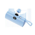 Capsule-shaped wireless power bank with digital display, shown in multiple colour options.