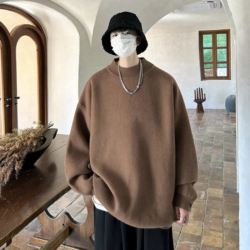 Men's loose fit round neck long sleeve sweater in a solid colour on a hanger.