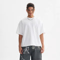 Man wearing a loose fit pure cotton American style T-shirt in apricot colour for summer.