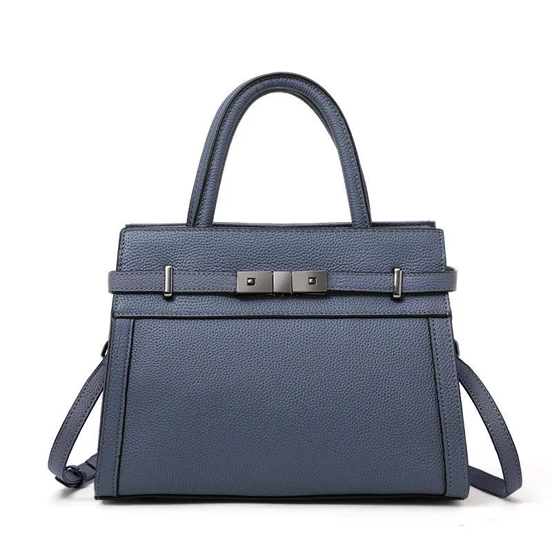 Women's black genuine leather crossbody clamshell handbag with multiple internal zip pockets.