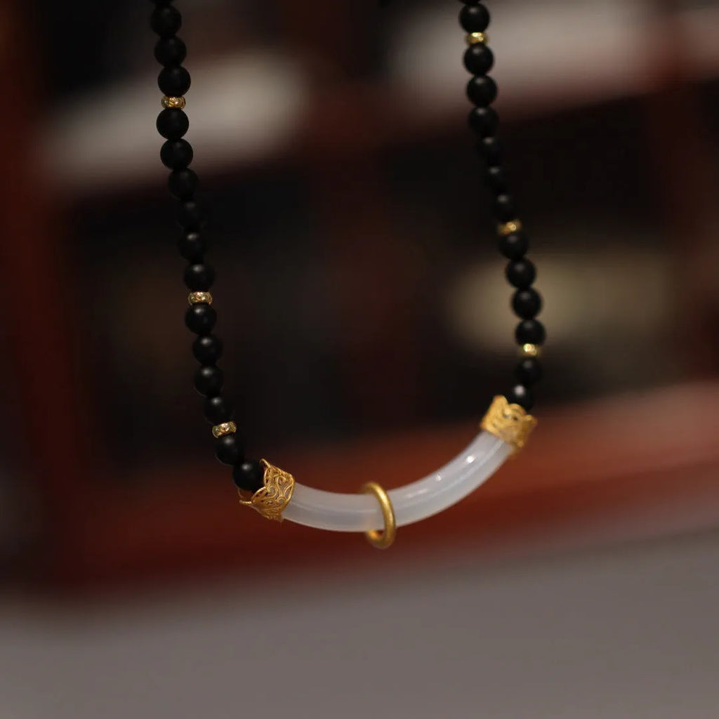 U-shaped Chinese style necklace with frosted black agate, white chalcedony, and 925 silver plating on a ball bead chain.