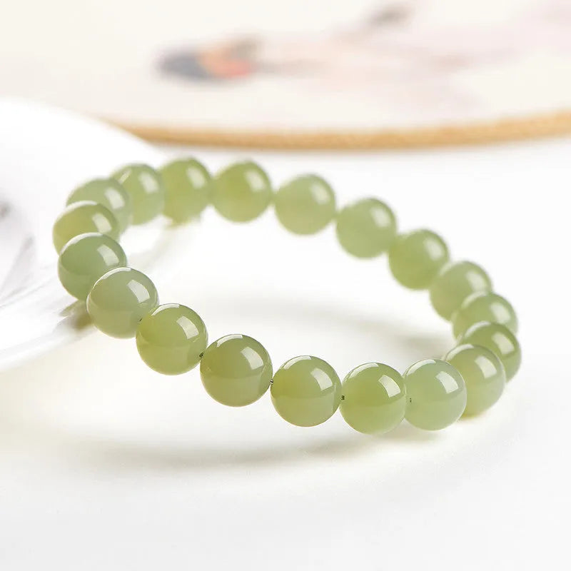 Polished Hetian jade ball bracelet in a casual unisex style with spherical beads.