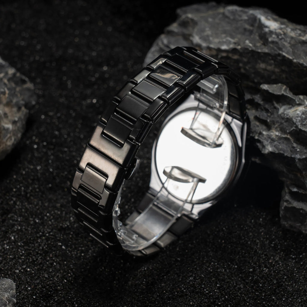Men's business casual watch with steel bracelet showing black dial and silver scales