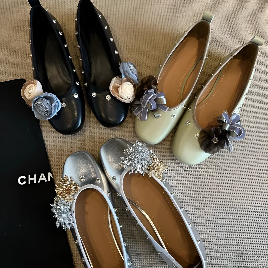 Silver Mary Jane buckle flats with DIY flower rivets on the strap, showing round toe and low top profile.